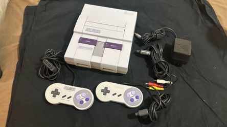 Super Nintendo entertainment system with two controllers and cables