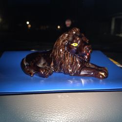 vintage Japanese redware ceramic lion figurine with a glossy brown glaze and yellow eyes. 