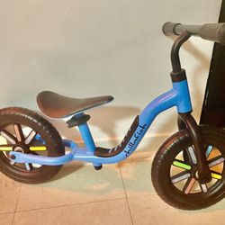 Infant/toddler chillafish blue balance bike with rainbow wheels