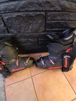 Black and orange Nordica skiing boots