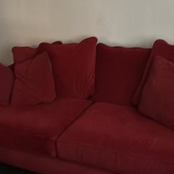 2 Red Velvety Sofas With Large Seat Cushions 