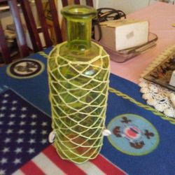 Green glass flower holder.