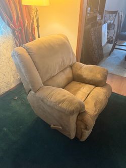 Tan rocker recliner.