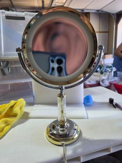 Two sided lighted vanity mirror