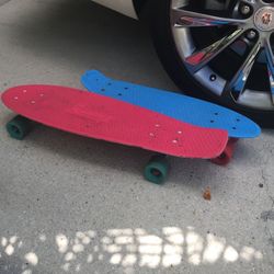 2 Pcs “ Penny” skate boards. Pink 27” & blue 22”.