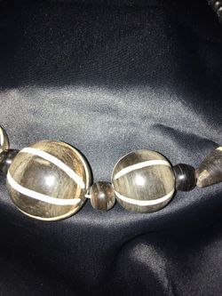 Collar de cuentas de piedras desiguales negras con líneas blancas