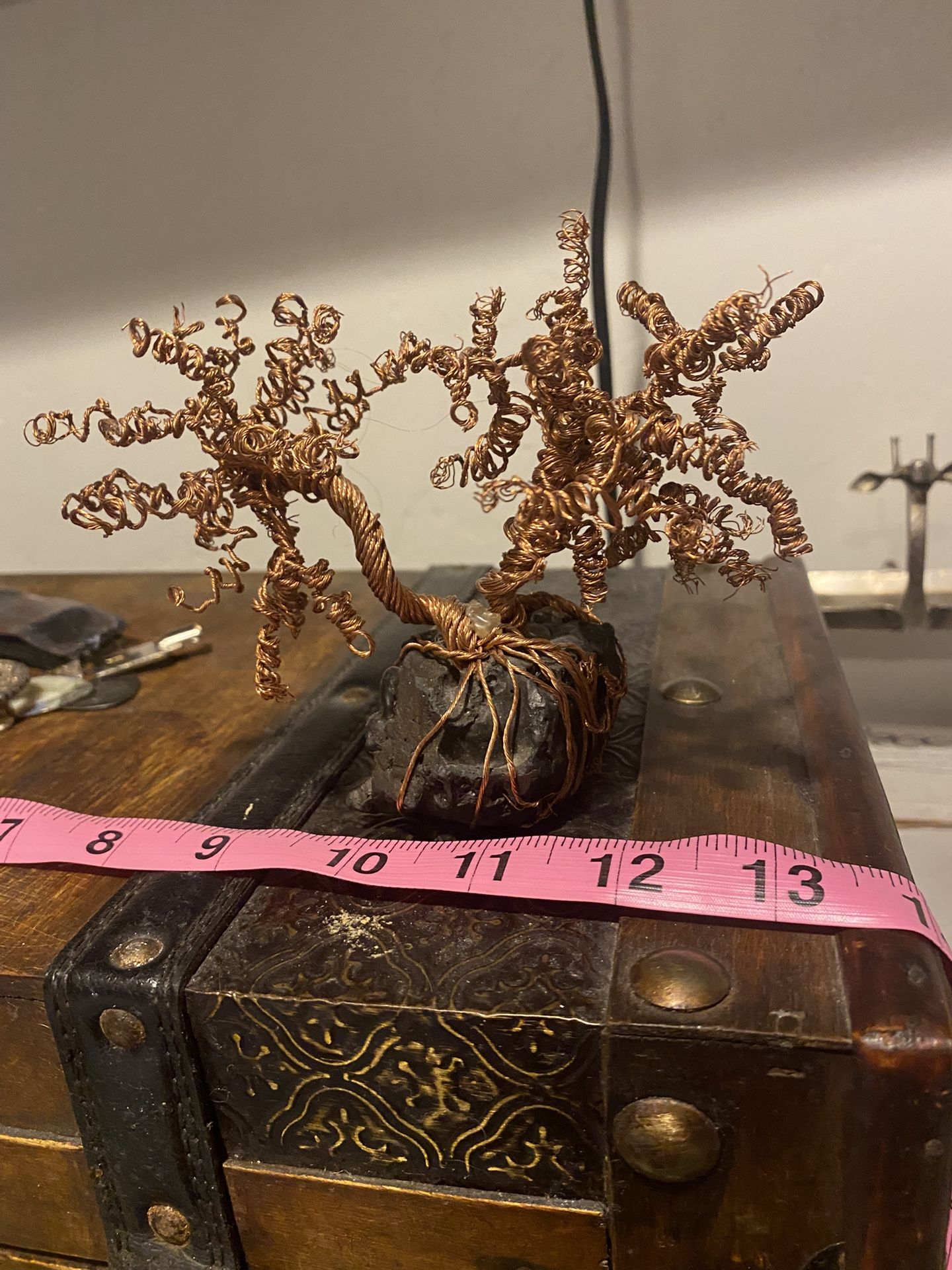 Copper wire tree on a meteorite.