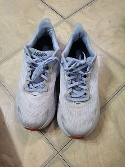 4 pairs of Hoka shoes.