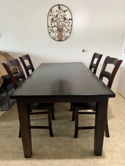 Solid wooden table + 4 matching chairs.