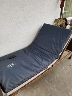 Hospital bed for sale includes mattress and side rails. Delivery Available