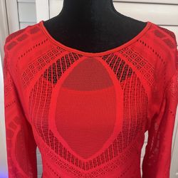 This is a red long-sleeve fishnet bodycon dress with an intricate geometric pattern
