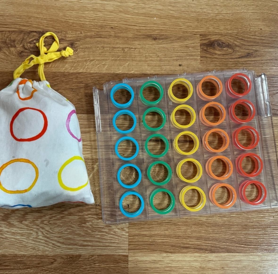 Lovevery Rainbow Connect 4 Toy with bag and dots