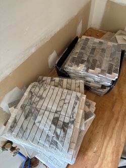 Backsplash tiles/materials/pallets (~30-35 total)