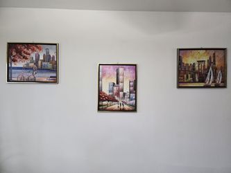 Three framed, abstract cityscape painting
