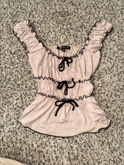 Pink top with black bow trimming
