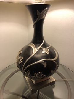 Lamp black with silver ornate detail. The lamp shade needs to be replaced or cleaned but other then that it's in great condition.