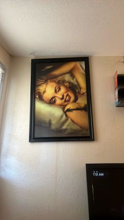 This framed print of Marilyn Monroe lying on a pillow