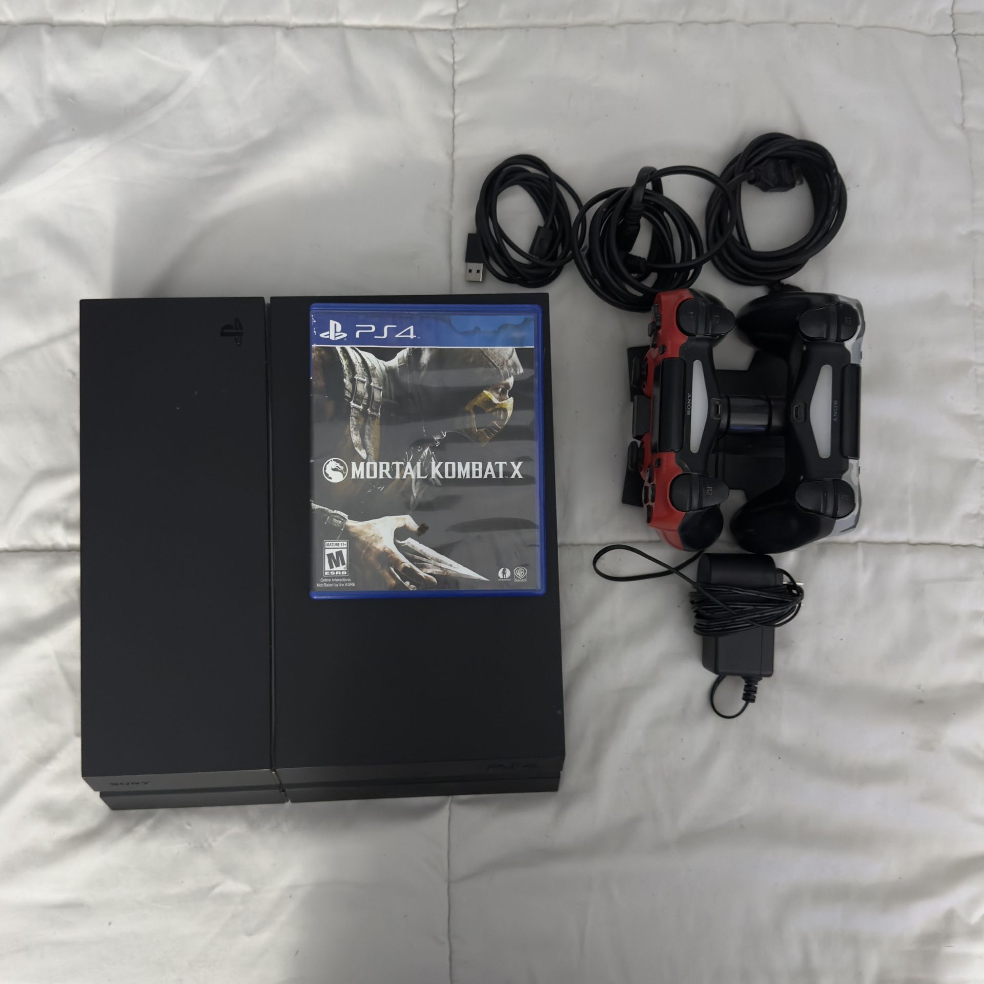 PlayStation 4 PS4 (2 working remotes & mortal kombat) includes remote charging station