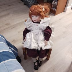 Porcelain doll with free chair