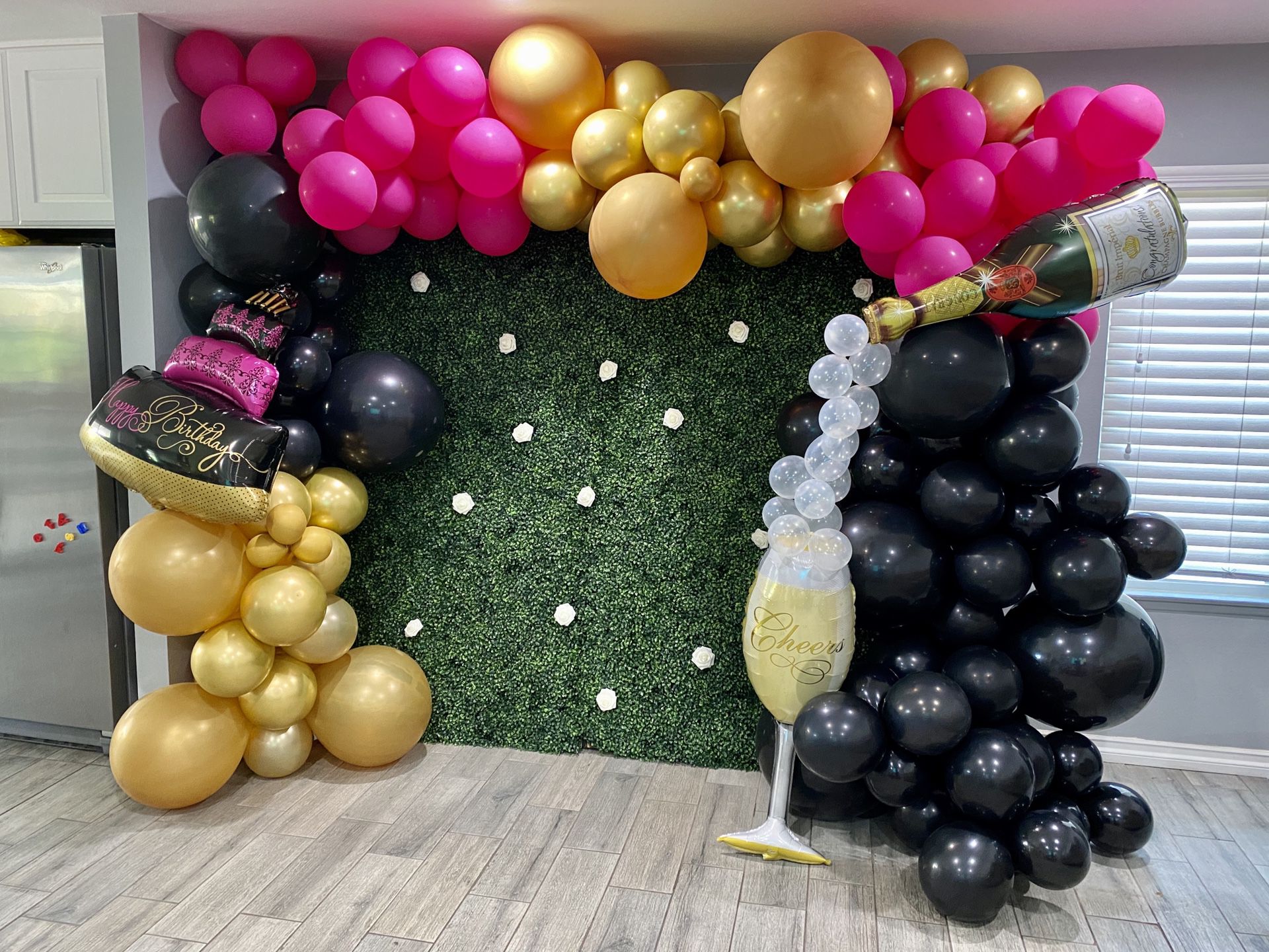 Hedge wall backdrop and balloons