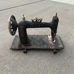 Antique Ruby sewing machine with hand wheel thread spool pin on top and needle
