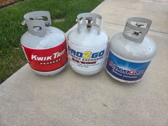 Three propane canisters- two empty, one nearly empty