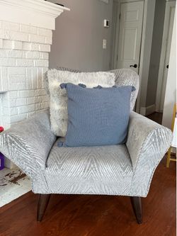 Light gray chair and decor pillow.
