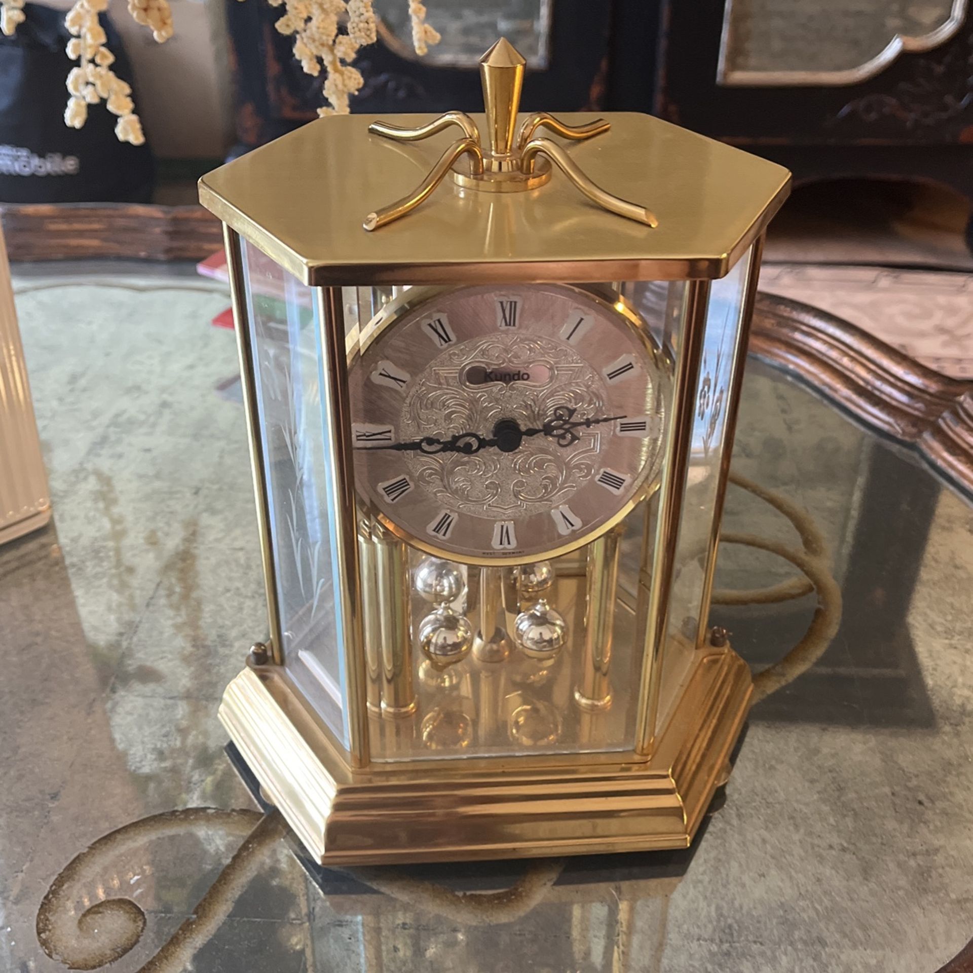 Brass and glass clock works on battery excellent condition