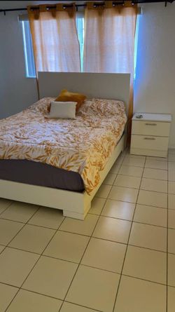 Queen bed with bedside table