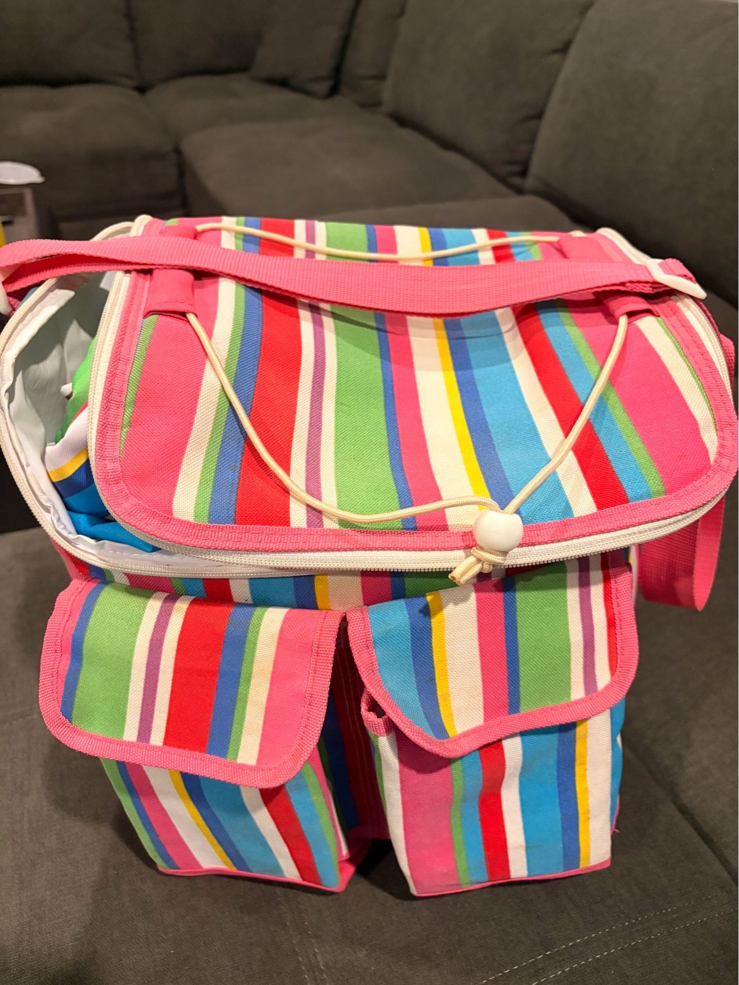 Picnic cooler with blanket and silverware.