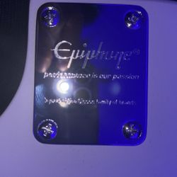 white and black guitar from epiphone