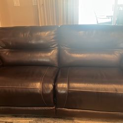 New dark chocolate leather couch, reclining on both sides, non smoking no pets home, too big for our home.