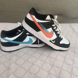 This is a pair of Women's Nike Dunk Low "Multi-Swoosh" sneakers in the white, black, Rush Pink, and Washed Teal colorway