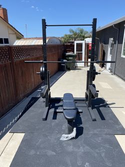 Deluxe Gym set up- Includes everything in picture- Squat stand, Bench, bar, bumper plates 