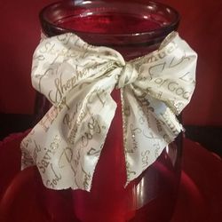 9" Tall - Red Glass Jar with Ribbon and Wrapped red candle inside