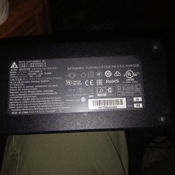 This image displays an AC/DC adapter manufactured by Delta Electronics, Inc. 