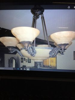 Beautiful chandelier brass and made up with shells