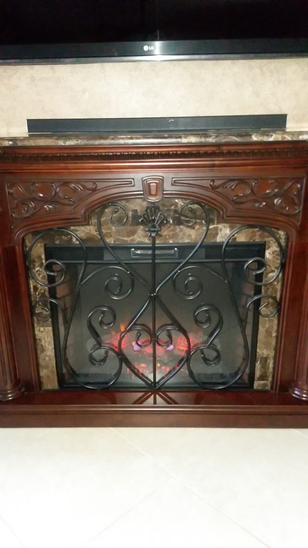 Mahogany electric fireplace with granite top for Sale in Boca
