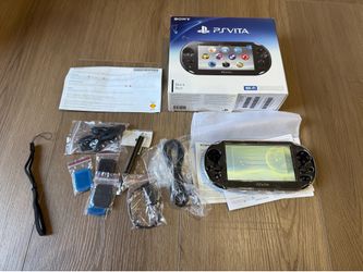 PlayStation  Vita handheld with accessories and box