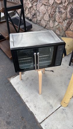 Oster French Door Digital Air Fry Countertop Oven with a stand
