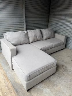 Gray sectional couch with reversible chaise