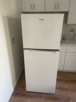 New 24 inch wide 11.6 cu in. Whirlpool Refrigerator / freezer.