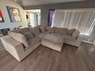 Light grey sectional couch with ottoman