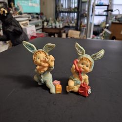 Vintage K's Collection Set Of 2 Babies In Blue Bunny Suits W/Ears-One Holding A Doll & One On A Vintage Red ☎️  In Resin 3"H