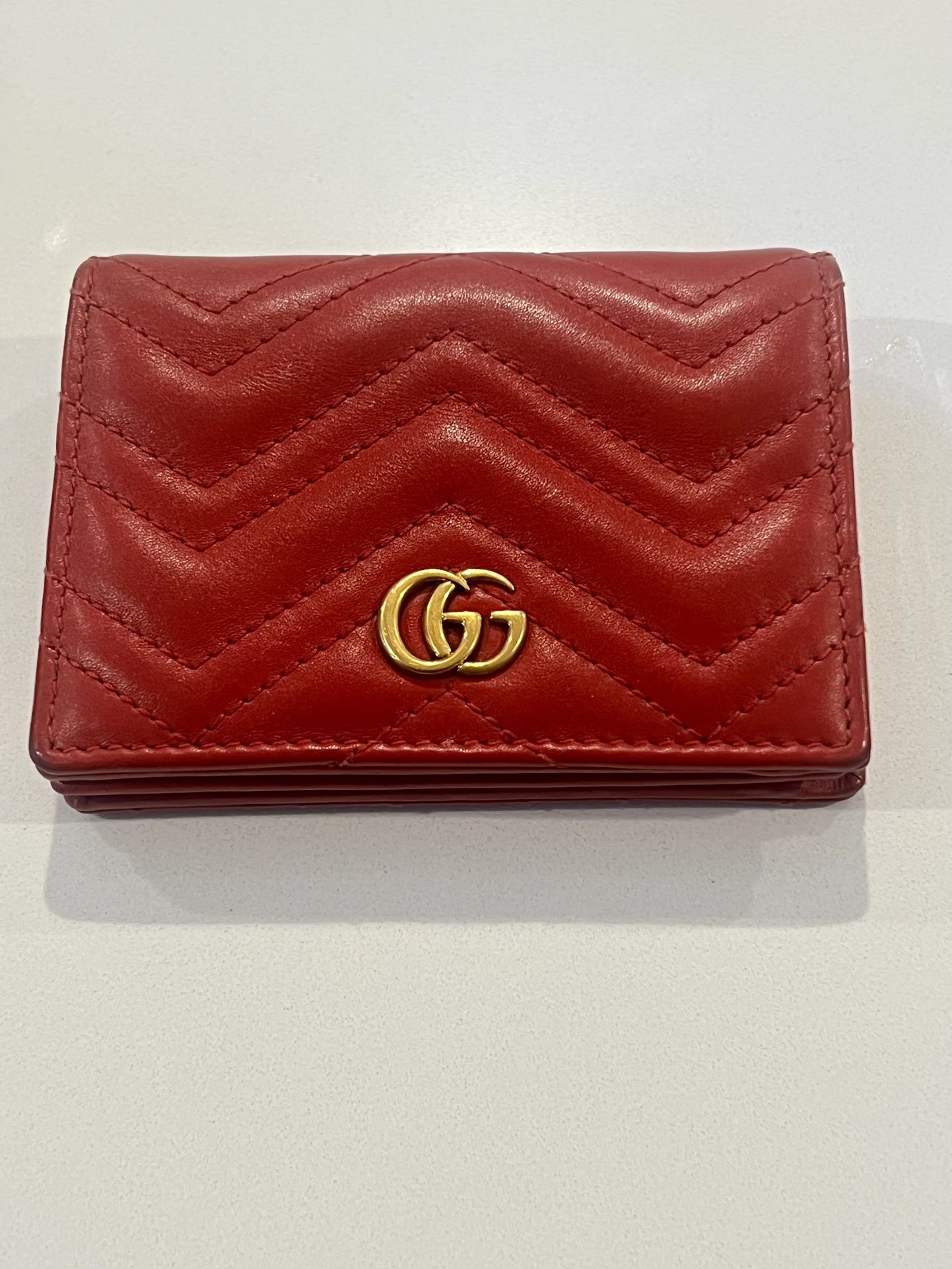Red Gucci GG Marmont wallet with gold hardware