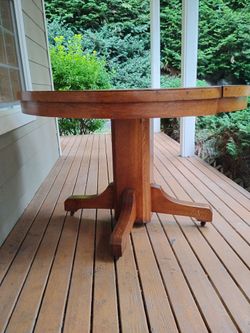 Heavy sturdy round wood table - rolling wheels