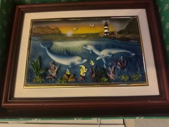 Dolphin art piece with three dolphins swimming with fish and coral, with a lighthouse and mountains in the background #dolphins #ocean 3D figures The