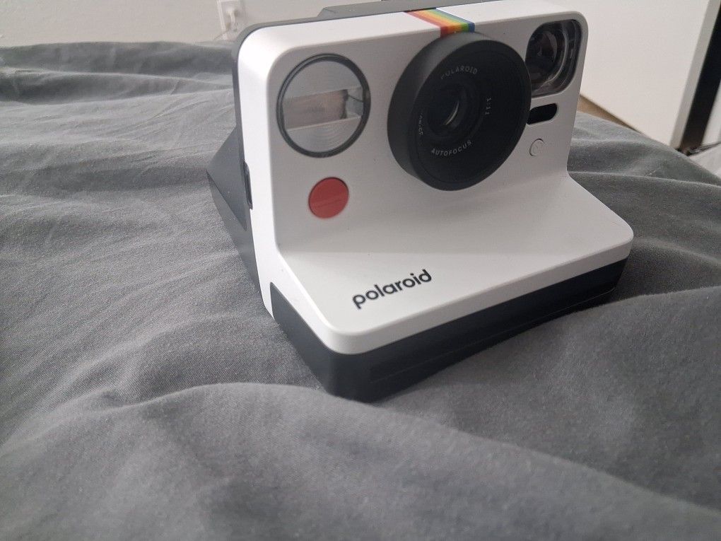 Polaroid Now Instant Camera, most likely a Generation 2 model, in the "Black & White" or "Panda" color scheme.
