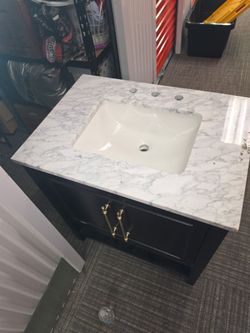 Black bathroom vanity with marble top