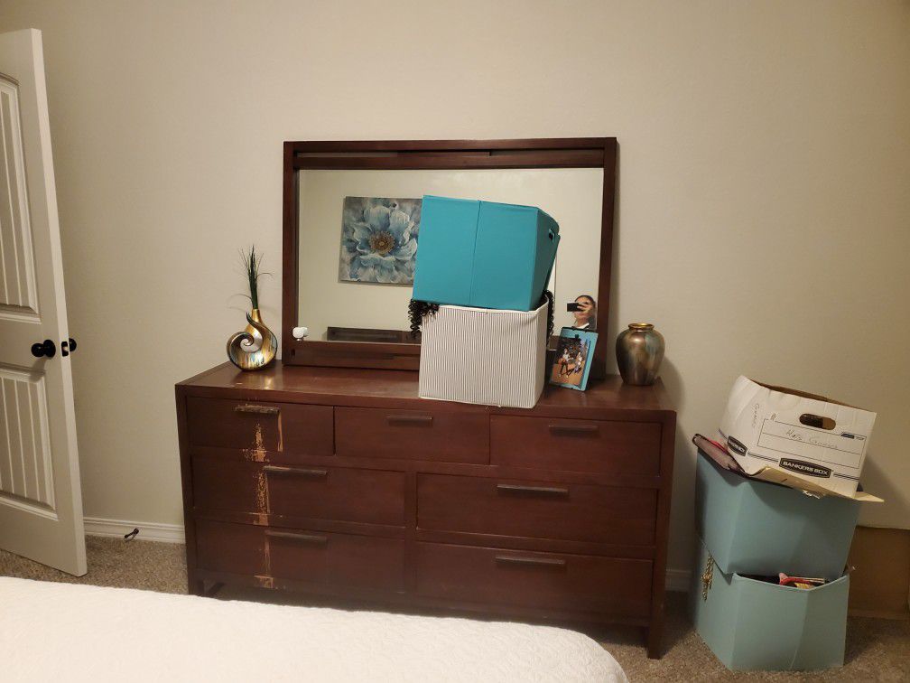 Bed frame, 2 mattresses, back board, 2 nightstands, dresser and mirror. Real wood.